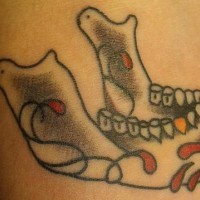 Sugar skull mandible with golden tooth tattoo