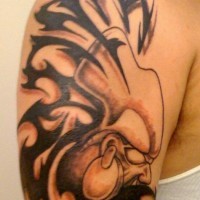 el tatuaje tribal del perfil de un guerrero azteca hecho en el brazo