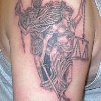 Blind justice statue with angel tattoo