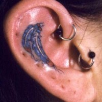 Feathers talisman tattoo on ear