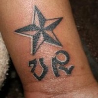 Star with initials wrist tattoo