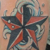 Red and black star in sea waves tattoo