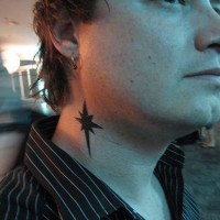 Small black tall star tattoo