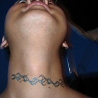 Flower tracery tattoo on front neck