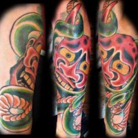 Red desperate horned mask forearm tattoo