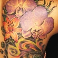 Large colourful flowers and eye tattoo
