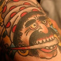 Colored tattoo of pirate with dagger in the mouth