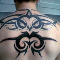 Traditional back tattoo with black signs