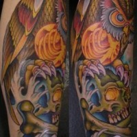 Leg tattoo, colourful  owl is sitting on skull