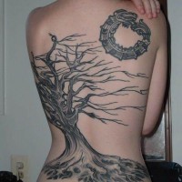 Back tattoo of black withered tree