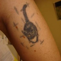 Waiting black cat arm tattoo