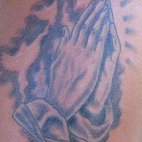 Praying hands and shining tattoo
