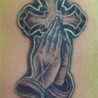 Praying hands and large cross tattoo