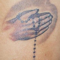 Young Praying hands tattoo