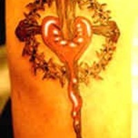 Bleeding heart and wooden cross tattoo