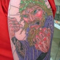 Angry jesus knuckles tattoo on shoulder