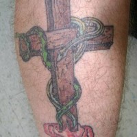 Wooden cross and snake tattoo