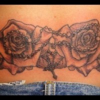 Rosary and roses lower back tattoo