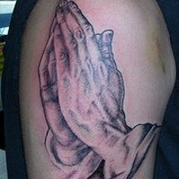 Realistic praying hands tattoo