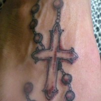 Rosary bead with blood tattoo