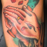 Praying hands with gum tattoo