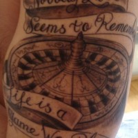 Roulette wheel with motto on ribbon tattoo