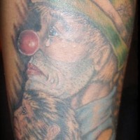 Sad hobo clown with monkey tattoo