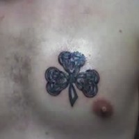 Black tracery shamrock tattoo on chest