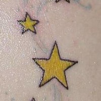 Shooting yellow  stars tattoo