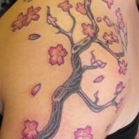 Shoulder tattoo, tall tree with many flowers