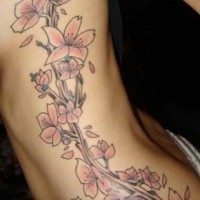Side tattoo, many beautiful, pink flowers on tree