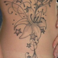Le tatouage de flanc avec des orchidées décorées avec beaucoup d'étoiles
