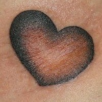 Simple red heart tattoo