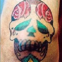 Sugar skull with roses tattoo