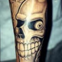 Smiling skull tattoo on arm