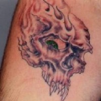 Flaming monster skull tattoo