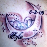 Sleeping baby on crescent tattoo