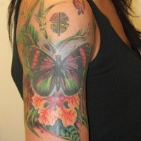 Colourful butterfly in greens tattoo