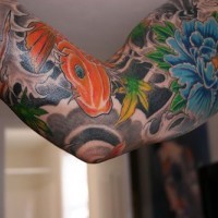 Asian style sleeve tattoo with blue flower and koi fish