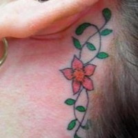 Tatuaje en color tracería floral detrás de la oreja