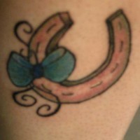 Small horseshoe with blue bow tattoo