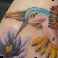 Small hummingbird in details tattoo