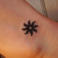 Small tribal black sun tattoo