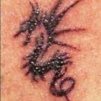 Black ink tribal seahorse tattoo