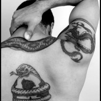 Snake aroung football ball tattoo