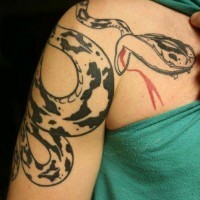 Black ink snake tattoo on shoulder