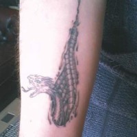 Snake under skin rip tattoo on wrist