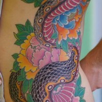 Large snake and flowers colourful tattoo on side