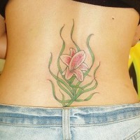 Pink lily tattoo on lower back