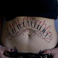 Stomach tattoo, unloveable, designed, red and black  inscription